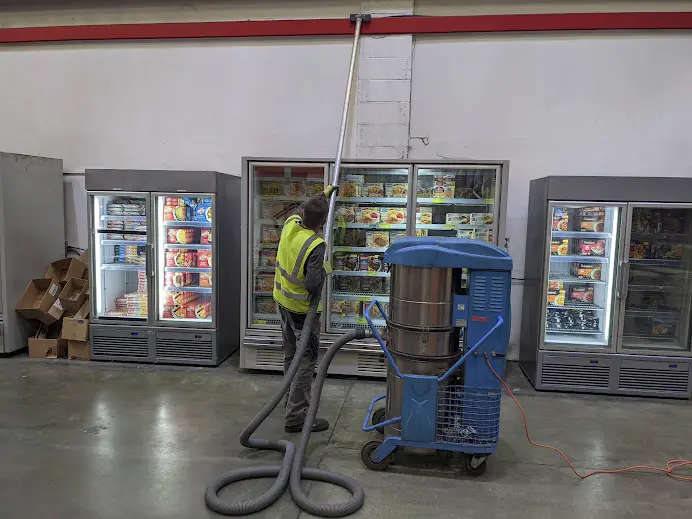 Industrial vacuum cleaner in action at a Glasgow warehouse